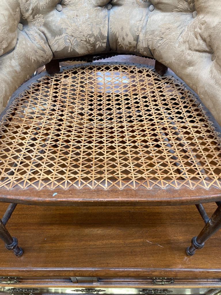 A late Victorian walnut caned seat back armchair